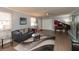 Elegant living room with a leather sofa, glass-top coffee table, and hardwood floors at 11 Eastern Ave, Brownsburg, IN 46112