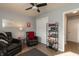 Relaxing sitting room featuring leather chairs, built-in shelving, and hardwood floors at 11 Eastern Ave, Brownsburg, IN 46112