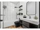 Modern bathroom with black vanity, white quartz countertop and a black framed mirror at 1125 California St, Columbus, IN 47201