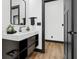 Modern bathroom with black vanity, floating shelves, and a black framed mirror at 1125 California St, Columbus, IN 47201