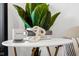 White side table with books, a mug, and decorative chain at 1125 California St, Columbus, IN 47201