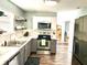 Modern kitchen with gray cabinets, stainless steel appliances, and marble countertops at 1165 Grassy Creek Cir, Franklin, IN 46131