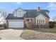 Brick house with gray siding, attached garage, and landscaping at 11725 Capistrano Dr, Indianapolis, IN 46236