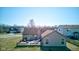 An aerial shot shows the home's backyard deck and the surrounding neighborhood at 12216 Laurelwood Ct, Indianapolis, IN 46236