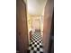 Hallway bathroom with a black and white checkerboard floor and whimsical shower curtain at 12216 Laurelwood Ct, Indianapolis, IN 46236