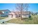 A sunny day highlights this single-story home with attached two car garage, brick accents, and a mature tree at 12216 Laurelwood Ct, Indianapolis, IN 46236