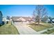 A sunny day highlights this single-story home with attached two car garage, brick accents, and a mature tree at 12216 Laurelwood Ct, Indianapolis, IN 46236