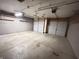 Three car garage featuring overhead lighting, storage shelves, and ample room for vehicles at 12216 Laurelwood Ct, Indianapolis, IN 46236
