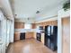 Bright kitchen with wooden cabinets, black appliances, and a window for natural light at 12216 Laurelwood Ct, Indianapolis, IN 46236