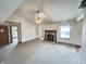 Bright living room with fireplace, vaulted ceiling and a ceiling fan fixture at 12216 Laurelwood Ct, Indianapolis, IN 46236
