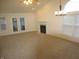 Spacious living room with carpet, fireplace and sunroom access at 1243 Easton Point Dr, Greenwood, IN 46142