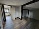 Bedroom with view of kitchen and wood-look flooring at 2826 Station St, Indianapolis, IN 46218
