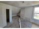 Unfinished attic bedroom with sloped ceilings and window at 2955 N Olney St, Indianapolis, IN 46218