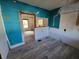 Unfinished kitchen with teal walls and new flooring at 2955 N Olney St, Indianapolis, IN 46218