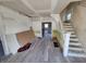 Under renovation living room with new flooring and exposed staircase at 2955 N Olney St, Indianapolis, IN 46218