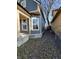 Side yard with a tree and gravel pathway, offering privacy and charm at 2955 N Olney St, Indianapolis, IN 46218