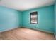 Empty bedroom with light teal walls and wood floors at 3830 Pineview Ln, Greenwood, IN 46142