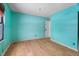 Empty bedroom with teal walls and wood floors at 3830 Pineview Ln, Greenwood, IN 46142