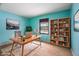 Comfortable home office with natural light, wooden desk, and a bookcase with plants and books at 3830 Pineview Ln, Greenwood, IN 46142