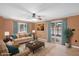 Cozy living room boasts comfortable seating, wood-paneled walls, and light-filled patio access at 3830 Pineview Ln, Greenwood, IN 46142