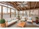 Cozy screened porch furnished with seating and a ceiling fan at 3830 Pineview Ln, Greenwood, IN 46142