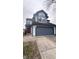 Two-story house with a gray and white exterior, attached garage, and a red front door at 4059 Eagle Cove W W Dr, Indianapolis, IN 46254
