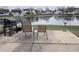 Small patio with grill and chairs overlooking a pond at 4059 Eagle Cove W W Dr, Indianapolis, IN 46254