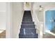 Stylish staircase with a navy and white patterned carpet runner at 4338 Briarwood Dr, Indianapolis, IN 46250