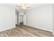 Bright bedroom with ceiling fan and wood-look flooring at 6239 Amber Creek Ln # 104, Indianapolis, IN 46237