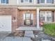 Brick front porch with a dark brown door and red chairs at 6451 E Aberdene Ct, Camby, IN 46113