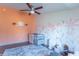 Bedroom featuring a floral accent wall, hardwood floors, and a ceiling fan at 6800 Beech Grove Rd, Martinsville, IN 46151