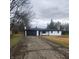 Charming one-story home features a black garage door and a well-maintained front yard at 6805 E County Road 100 S, Avon, IN 46123