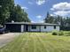 Charming white brick ranch home with dark trim, attached garage, and a well-manicured lawn at 6805 E County Road 100 S, Avon, IN 46123
