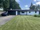 Charming white brick ranch home with dark trim, attached garage, and a well-manicured lawn at 6805 E County Road 100 S, Avon, IN 46123