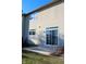 Townhouse exterior showcasing a sliding glass door leading to a patio at 7043 Tyler Ln, Indianapolis, IN 46217