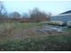 Open backyard space with overgrown weeds at 7099 S 1100 W, Jamestown, IN 46147