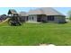 Large backyard with deck, playset, and green lawn at 7099 S 1100 W, Jamestown, IN 46147