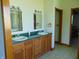 Bathroom featuring double sinks, wood cabinets, large mirrors and plenty of light at 7099 S 1100 W, Jamestown, IN 46147