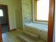 Bathroom featuring soaking tub, tiled surround, and glass-enclosed shower at 7099 S 1100 W, Jamestown, IN 46147