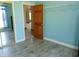 Neutral bedroom featuring wood look floors, closet, and bright lighting at 7099 S 1100 W, Jamestown, IN 46147