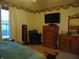 Bedroom with large bed, dresser, TV, and full-length mirror at 7099 S 1100 W, Jamestown, IN 46147