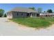 Back of home with three car garage, back patio, and playset at 7099 S 1100 W, Jamestown, IN 46147
