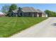 View of the home and gravel driveway showcases the home's setting at 7099 S 1100 W, Jamestown, IN 46147