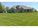 Charming brick home boasts a well-manicured lawn, creating a welcoming curb appeal at 7099 S 1100 W, Jamestown, IN 46147