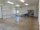 Inside the large shop building with white walls, lighting, and large garage door at 7099 S 1100 W, Jamestown, IN 46147