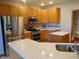 Kitchen with stainless steel appliances, granite counters, and wooden cabinets at 7099 S 1100 W, Jamestown, IN 46147