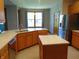 Well-lit kitchen with stainless steel appliances, stone countertops, and tile flooring at 7099 S 1100 W, Jamestown, IN 46147