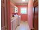 Bright laundry room with white cabinets, sink, and washer/dryer at 7099 S 1100 W, Jamestown, IN 46147