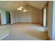 Large living room with vaulted ceiling, two ceiling fans, and sliding glass doors at 7099 S 1100 W, Jamestown, IN 46147