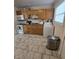 Galley kitchen with wood cabinets and tile floor at 7328 Parkside Dr, Lawrence, IN 46226